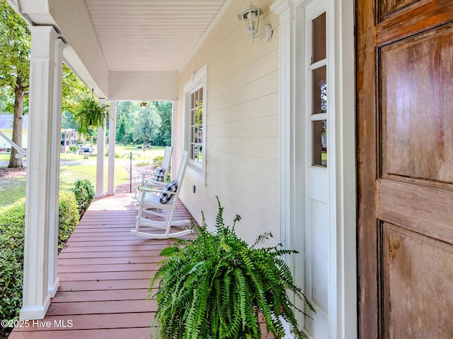 wooden terrace featuring a porch