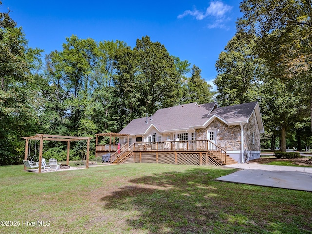 view of yard featuring a wooden deck, a pergola, and a patio