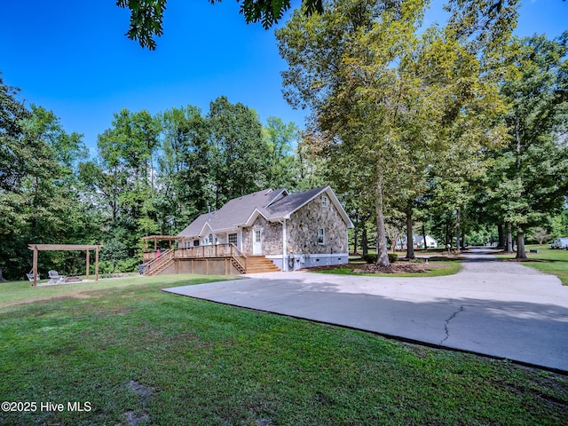 view of front of house with a pergola, a deck, and a front lawn