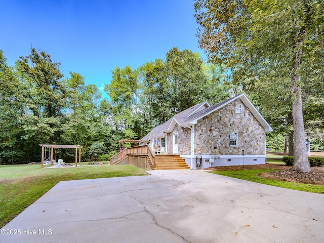 view of side of property with a yard and a pergola