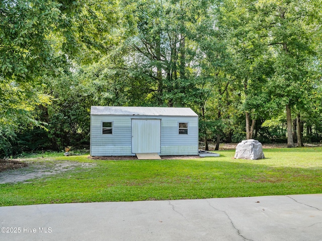 view of outbuilding with a yard