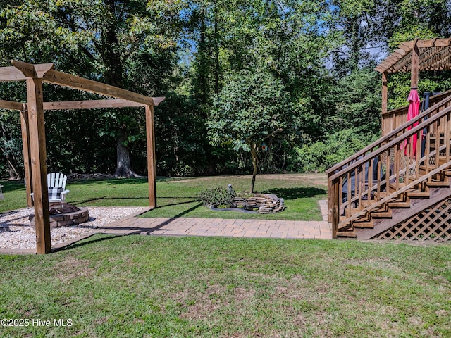 view of yard with an outdoor fire pit and a patio