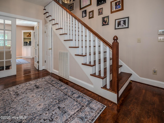 stairs with hardwood / wood-style floors