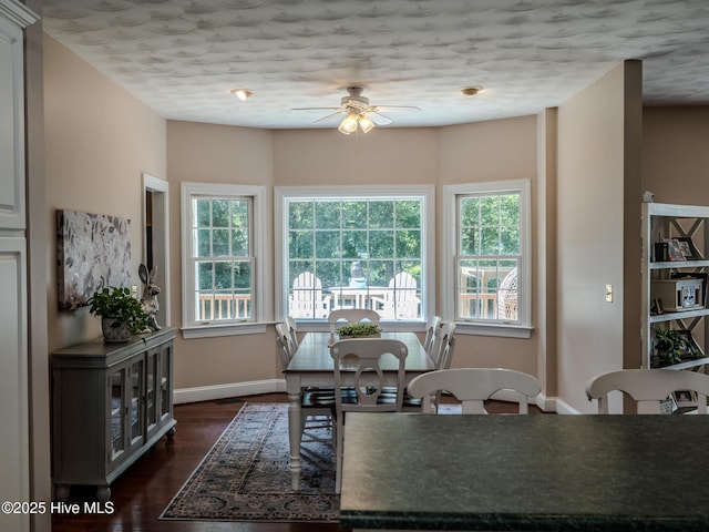 dining room with dark wood-type flooring and ceiling fan