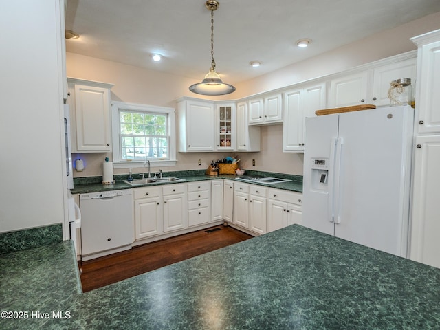 kitchen with white cabinetry, sink, white appliances, and hanging light fixtures