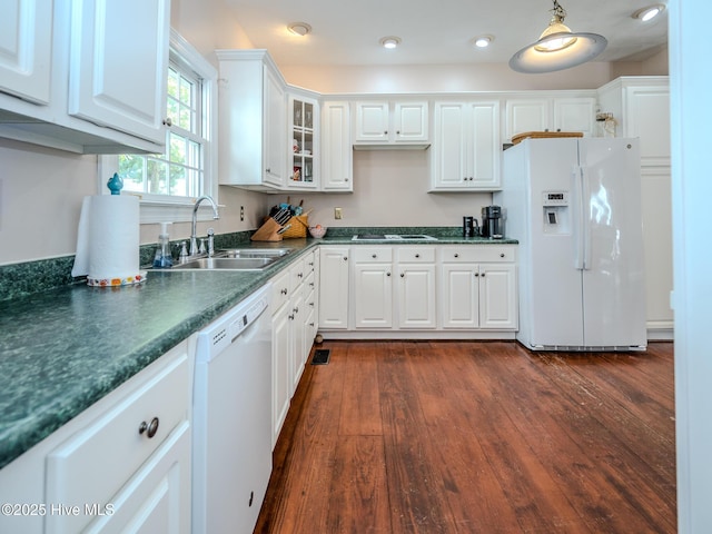 kitchen featuring white cabinetry, white appliances, dark hardwood / wood-style flooring, and sink