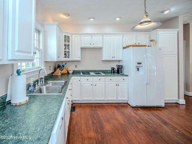 kitchen with dark hardwood / wood-style floors, pendant lighting, white cabinetry, sink, and white appliances