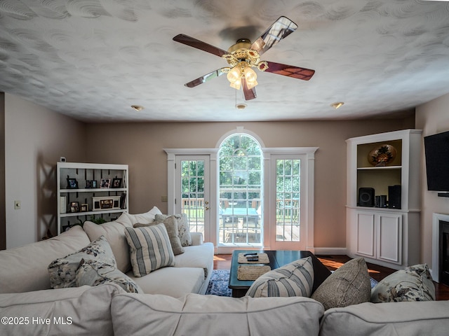 living room with wood-type flooring and ceiling fan