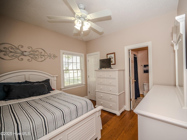 bedroom featuring ceiling fan, a textured ceiling, and dark hardwood / wood-style flooring