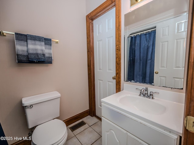 bathroom featuring tile patterned flooring, vanity, and toilet