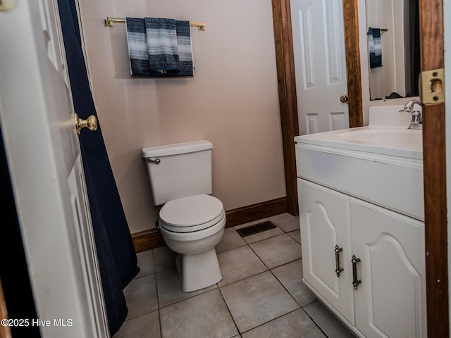 bathroom with vanity, toilet, and tile patterned flooring