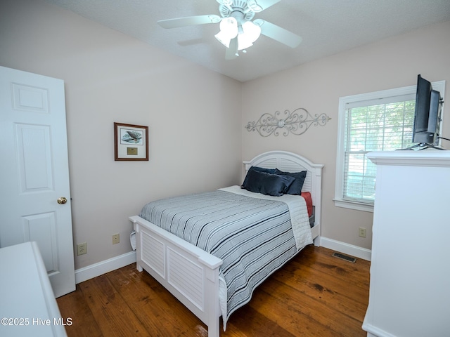 bedroom with dark wood-type flooring and ceiling fan