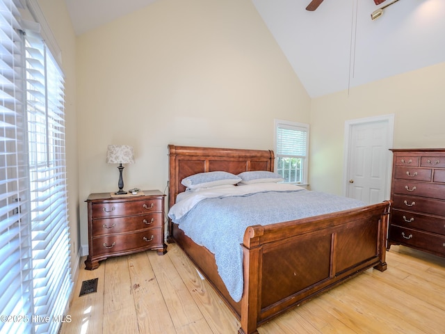 bedroom featuring high vaulted ceiling, ceiling fan, and light wood-type flooring