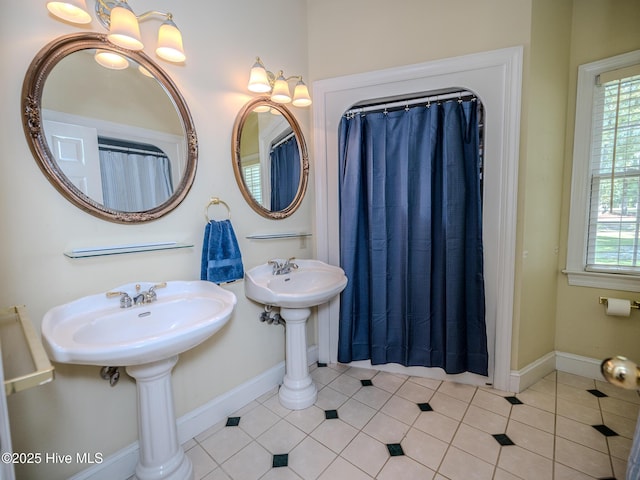 bathroom featuring tile patterned flooring and dual sinks