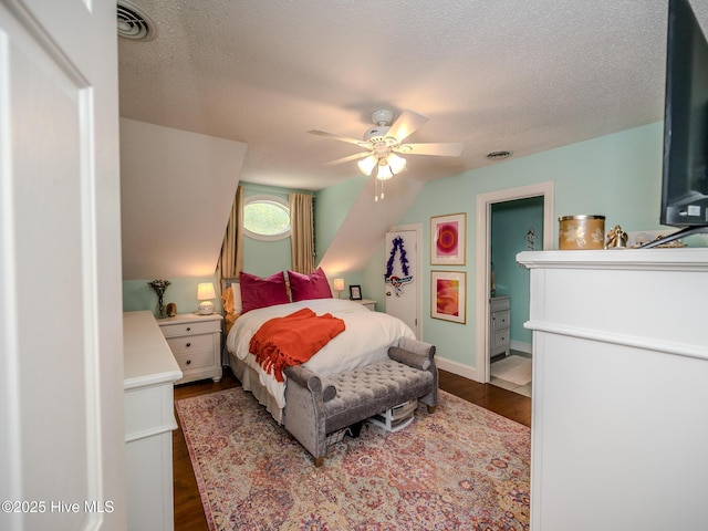 bedroom featuring dark hardwood / wood-style flooring, ceiling fan, and a textured ceiling