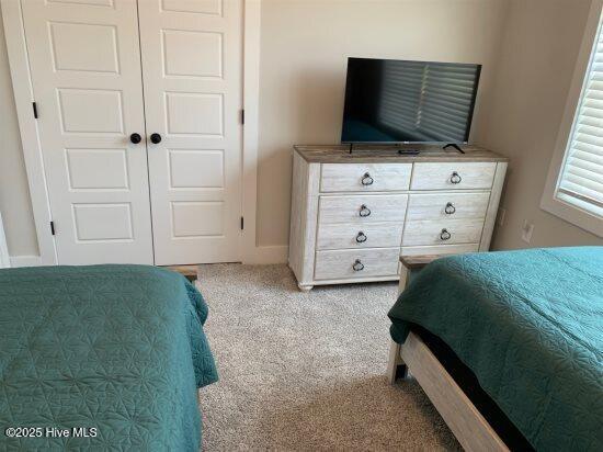 carpeted bedroom featuring a closet