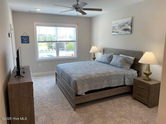 carpeted bedroom with ceiling fan