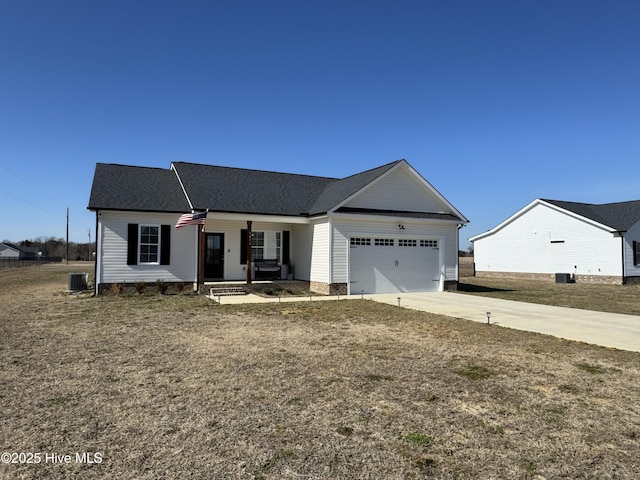 view of front of home featuring a garage, a front yard, central AC, and covered porch