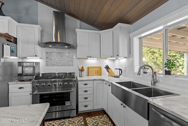 kitchen with white cabinetry, light stone countertops, wall chimney exhaust hood, and appliances with stainless steel finishes