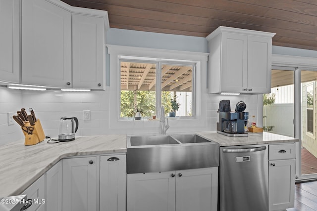 kitchen with dishwasher, sink, white cabinets, backsplash, and light stone countertops