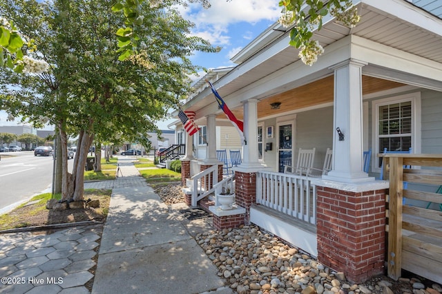 view of exterior entry with covered porch