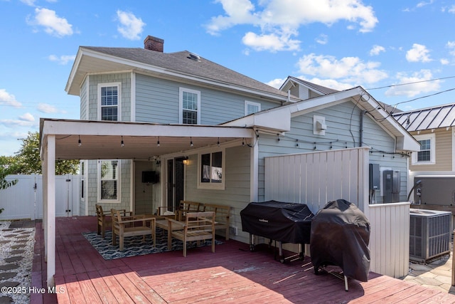 rear view of house featuring a deck and central air condition unit