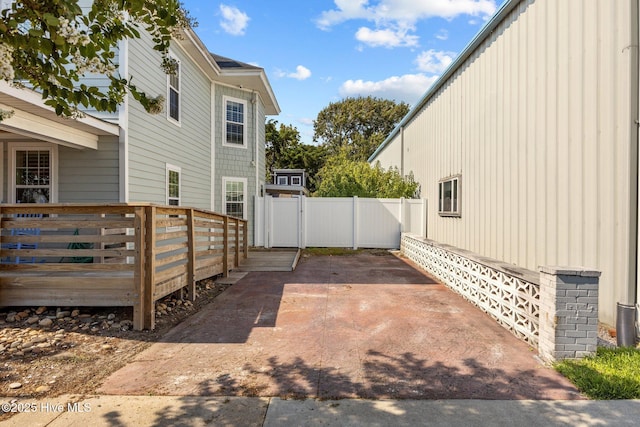 view of home's exterior featuring a patio and a deck