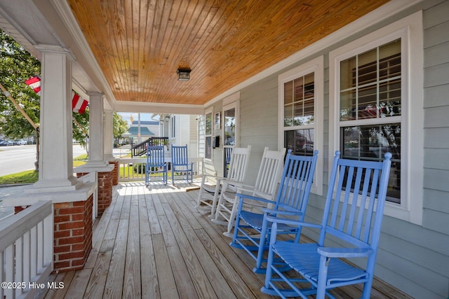 wooden terrace with a porch