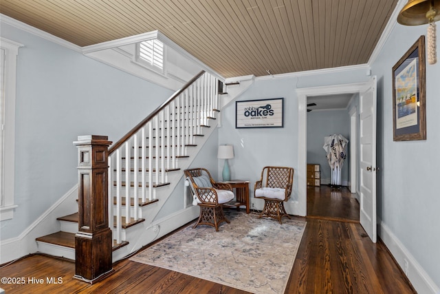 staircase featuring ornamental molding, wood-type flooring, and wooden ceiling