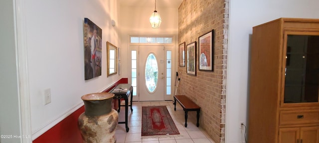 tiled foyer with brick wall