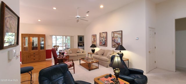 living room with ceiling fan and high vaulted ceiling