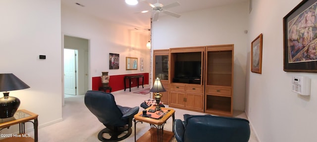 carpeted living room with ceiling fan