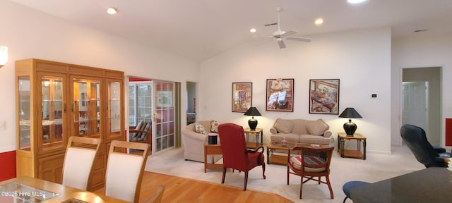 living room featuring ceiling fan, high vaulted ceiling, and light hardwood / wood-style flooring