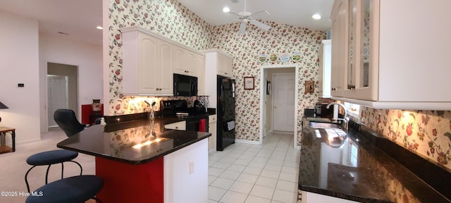 kitchen with sink, white cabinetry, kitchen peninsula, ceiling fan, and black appliances