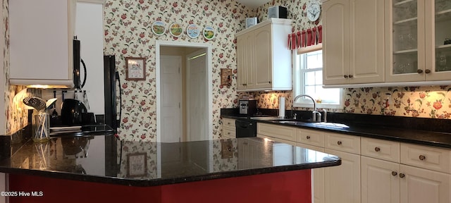 kitchen with white cabinetry, kitchen peninsula, sink, and black appliances