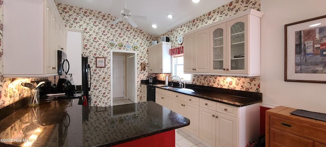 kitchen with white cabinets, sink, vaulted ceiling, and black appliances