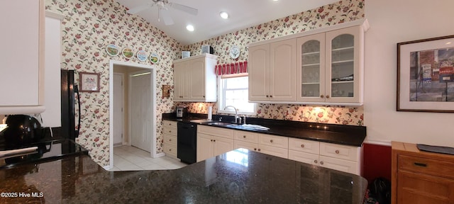 kitchen with lofted ceiling, sink, ceiling fan, black dishwasher, and light tile patterned flooring