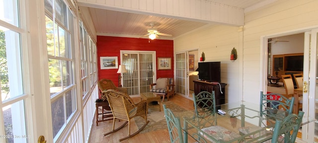 sunroom / solarium featuring wood ceiling and ceiling fan