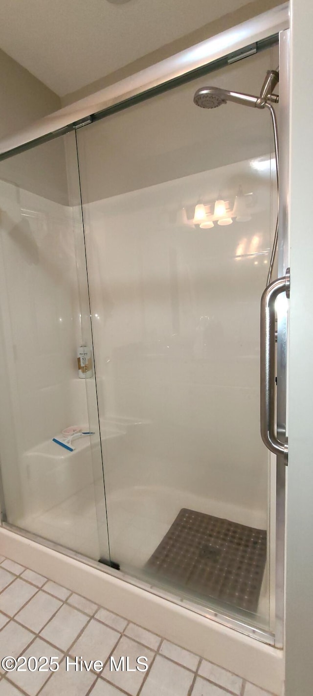 bathroom featuring an enclosed shower and tile patterned floors