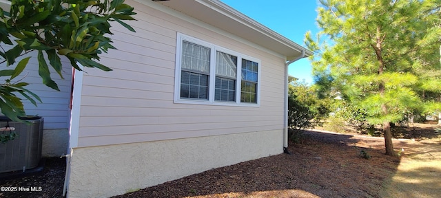 view of side of home featuring central AC unit