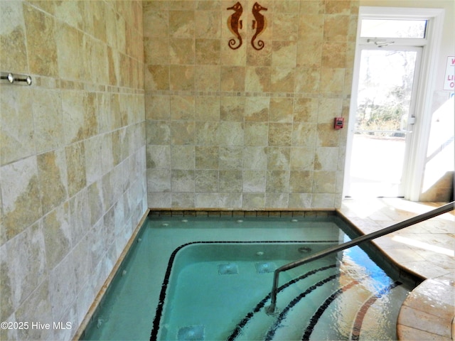 view of swimming pool with an indoor in ground hot tub