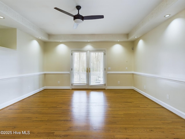 unfurnished room featuring hardwood / wood-style floors, french doors, and ceiling fan