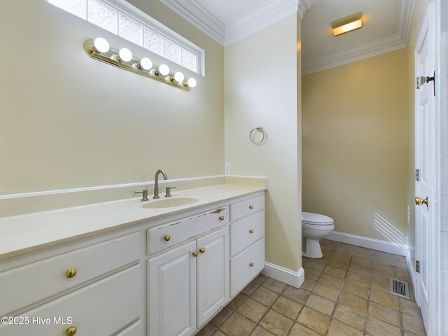 bathroom with vanity, crown molding, and toilet