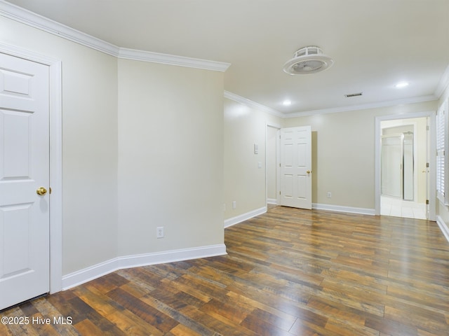 empty room with crown molding and dark wood-type flooring