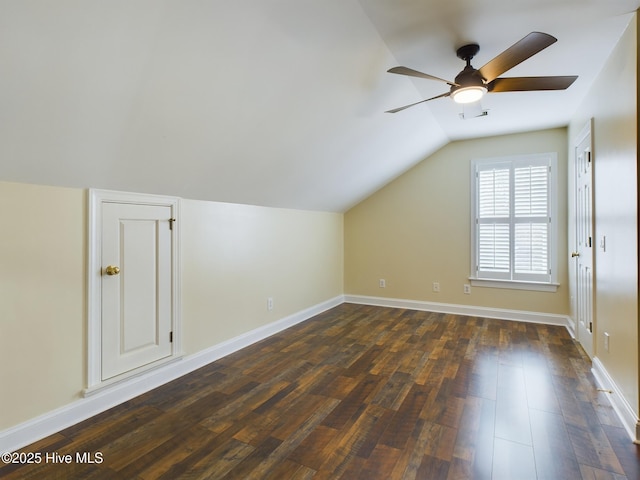 additional living space with lofted ceiling, dark wood-type flooring, and ceiling fan