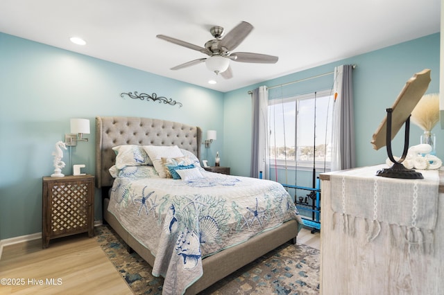 bedroom featuring light hardwood / wood-style flooring and ceiling fan