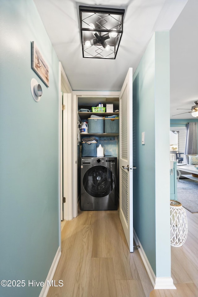 laundry area featuring ceiling fan, washer / clothes dryer, and light hardwood / wood-style floors