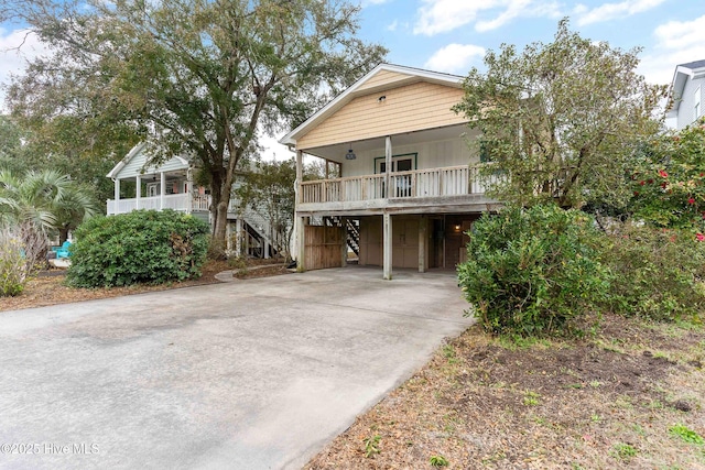 view of front of home with a carport and covered porch