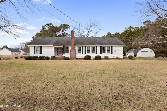 ranch-style house with a garage, an outdoor structure, and a front yard