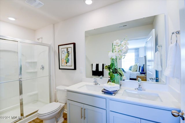 bathroom featuring walk in shower, vanity, and toilet